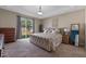 This primary bedroom suite features a tray ceiling and a sliding glass door to enjoy the natural sunlight at 570 Cascading Creek Ln, Winter Garden, FL 34787