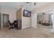 This office space has neutral colors and includes the TV and desk for a professional environment at 570 Cascading Creek Ln, Winter Garden, FL 34787