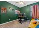 This green accent office has a desk and a sofa in a well lit setting at 570 Cascading Creek Ln, Winter Garden, FL 34787