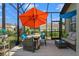 Inviting screened patio with wicker furniture and dining area offers a relaxing outdoor space at 570 Cascading Creek Ln, Winter Garden, FL 34787