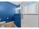 This shower features white subway tile with neutral tile flooring and a blue accent wall at 570 Cascading Creek Ln, Winter Garden, FL 34787