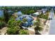 An aerial view of a charming blue home nestled among lush greenery and palm trees at 600 Bostwick Ave, Daytona Beach, FL 32118