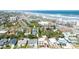 An aerial view of a charming blue home nestled among lush greenery and palm trees near the beach at 600 Bostwick Ave, Daytona Beach, FL 32118