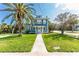 Charming two-story home with a landscaped lawn and inviting white-framed windows at 600 Bostwick Ave, Daytona Beach, FL 32118