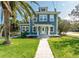 Charming two-story home with a landscaped lawn and inviting white-framed windows at 600 Bostwick Ave, Daytona Beach, FL 32118