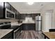 Updated kitchen features modern appliances, sleek dark cabinets, and granite countertops at 600 Bostwick Ave, Daytona Beach, FL 32118