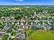 Beautiful residential area featuring well-maintained homes, mature trees, and serene lakeside views from above at 604 Fosters Grove Loop, Oviedo, FL 32765
