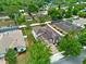 Two-story home with a three-car garage, featuring a brick driveway and mature trees along the streets at 604 Fosters Grove Loop, Oviedo, FL 32765