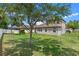 Large backyard with grassy lawn and mature tree at 604 Fosters Grove Loop, Oviedo, FL 32765