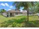 Well-maintained backyard with covered patio, pool, and fenced perimeter at 604 Fosters Grove Loop, Oviedo, FL 32765