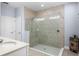 Ensuite bathroom featuring a glass shower with tiled walls, a seat, and a neutral color palette at 604 Fosters Grove Loop, Oviedo, FL 32765
