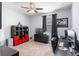 Bedroom with carpet, a ceiling fan, a window with curtains, a desk, and a red and black shelf at 604 Fosters Grove Loop, Oviedo, FL 32765