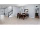 Spacious dining room with tile floors, chandelier lighting, access to the main entry and an adjacent room at 604 Fosters Grove Loop, Oviedo, FL 32765