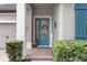 Close-up of a charming front entryway featuring a decorative blue door with sidelights and a colorful welcome sign at 604 Fosters Grove Loop, Oviedo, FL 32765