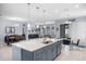 Open concept kitchen with white cabinets, stainless steel appliances, a large island, and open to the living area at 604 Fosters Grove Loop, Oviedo, FL 32765