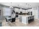 Stylish kitchen features white cabinets, stainless steel appliances, an island with seating, and an adjacent breakfast nook at 604 Fosters Grove Loop, Oviedo, FL 32765