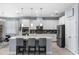 Modern kitchen with white cabinets, stainless steel appliances, tile backsplash, and a large center island at 604 Fosters Grove Loop, Oviedo, FL 32765