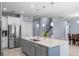 Bright kitchen boasts stainless appliances, a large island with a sink, and modern pendant lighting at 604 Fosters Grove Loop, Oviedo, FL 32765
