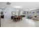 Open floor plan of dining and living areas featuring neutral paint, tile floors, and large windows at 604 Fosters Grove Loop, Oviedo, FL 32765