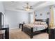 Spacious main bedroom featuring a ceiling fan, tray ceiling, neutral carpet, and lots of natural light at 604 Fosters Grove Loop, Oviedo, FL 32765