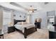 Light-filled main bedroom with a ceiling fan, tray ceiling, neutral carpet, and a television at 604 Fosters Grove Loop, Oviedo, FL 32765