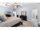 Main bedroom features a view of the ensuite bathroom, a television, and neutral décor at 604 Fosters Grove Loop, Oviedo, FL 32765