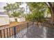 Backyard view featuring deck, storage sheds, mature trees and partially fenced yard at 6354 Hill Rd, Orlando, FL 32810