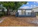 Backyard featuring a wooden deck, perfect for outdoor relaxation and entertainment, with a backdrop of mature trees at 6354 Hill Rd, Orlando, FL 32810