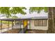 Charming single-story home with a bright yellow front door and covered carport at 6354 Hill Rd, Orlando, FL 32810