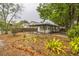 A charming single-story home with a covered porch and ramp, surrounded by unique landscaping, providing accessibility and curb appeal at 6354 Hill Rd, Orlando, FL 32810
