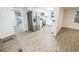 Open kitchen with stainless steel appliances and white cabinets that flows into living area at 6354 Hill Rd, Orlando, FL 32810