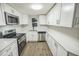 Modern kitchen with stainless steel appliances and sleek white cabinets at 6354 Hill Rd, Orlando, FL 32810