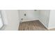 Laundry room featuring wood-look flooring, hookups, and a window providing natural light at 6354 Hill Rd, Orlando, FL 32810