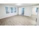 Bright living room featuring new flooring and fresh paint throughout at 6354 Hill Rd, Orlando, FL 32810