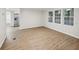 Bright living room featuring new floors and fresh paint with stainless steel appliances visible in the kitchen at 6354 Hill Rd, Orlando, FL 32810