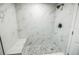 Modern shower featuring marble-look tile, a rainfall shower head, and a built-in bench at 6354 Hill Rd, Orlando, FL 32810
