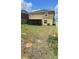 Backyard with partially covered porch, green grass, and privacy fence at 651 Taft Dr, Davenport, FL 33837