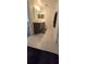 Bathroom featuring double sinks with sleek dark cabinetry and modern fixtures, white tiling and 