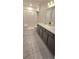 Bathroom featuring double sinks, a shower, and neutral decor at 651 Taft Dr, Davenport, FL 33837