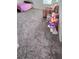 Bedroom with plush gray carpeting, an armchair, and a playset near a window at 651 Taft Dr, Davenport, FL 33837
