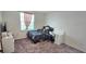 Bright bedroom with a bed, desk, dresser, and a window providing natural light at 651 Taft Dr, Davenport, FL 33837