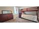 Bedroom with a wooden bunk bed, dresser, and a window for natural light at 651 Taft Dr, Davenport, FL 33837