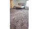 Spacious bedroom with gray carpeting, a bed frame, and a nightstand by the window at 651 Taft Dr, Davenport, FL 33837