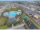 Aerial view of a community pool, playground, picnic cabana, and manicured greenery, creating an oasis at 651 Taft Dr, Davenport, FL 33837