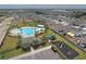 Aerial view of a community pool, playground, picnic cabana, manicured greenery, and neighborhood at 651 Taft Dr, Davenport, FL 33837
