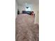 Loft area featuring a black leather couch and neutral carpeting at 651 Taft Dr, Davenport, FL 33837