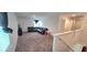 Loft space featuring a black leather couch, carpeting, and natural light at 651 Taft Dr, Davenport, FL 33837