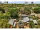 Aerial view of a neighborhood with lush trees and houses with the city skyline in the background at 706 Hillcrest St, Orlando, FL 32803