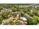 Charming yellow home with a white roof nestled among lush trees in a vibrant neighborhood at 706 Hillcrest St, Orlando, FL 32803