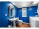 Bright bathroom with sink, toilet, mirror, window and laundry at 706 Hillcrest St, Orlando, FL 32803
